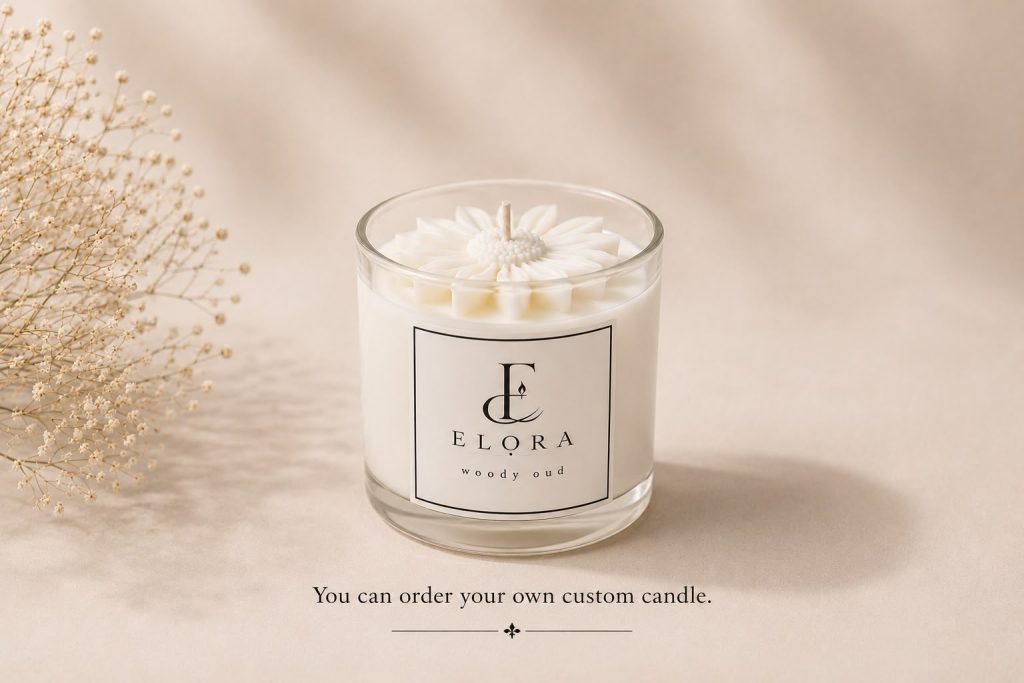 White ELORA candle with a sculpted flower top and custom-candle message on a cream backdrop